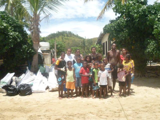 MES team with children of Solevu Village took time out for a photo shoot beside garbage bags being collected after the cleanup campaign